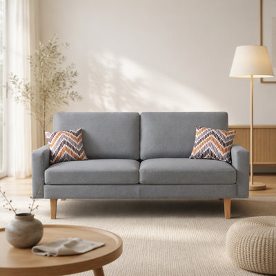 Canapé de 70 pouces en lin recouvert de tissu avec deux coussins décoratifs pour une assise confortable et des espaces de vie modernes.