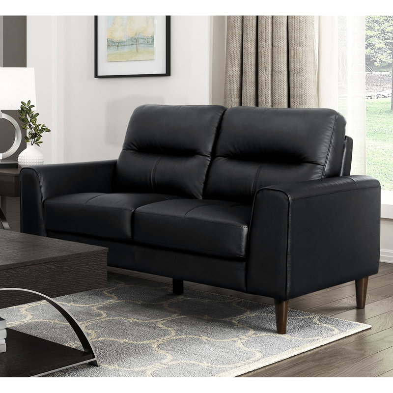 Cuir noir avec coussins en mousse à haute densité, structure en bois massif et en contreplaqué, largeur du produit de 34,5 po, accoudoirs à grain supérieur noir, pieds à finition brune, hauteur du siège de 18 po, style moderne polyvalent