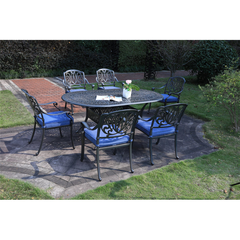 Annecorinne 6 - Person Patio Dining Set with Oval Table , Cushions Included, Navy Blue, Dessert Night
