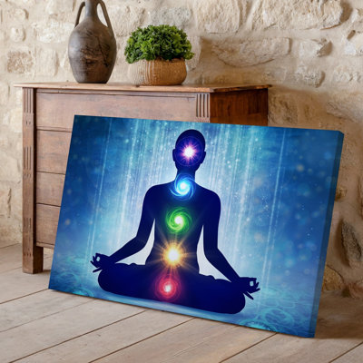 Canvas A Serene Figure Sits Cross Legged In A Meditative Pose Wall Art Surrounded By A Vibrant Aura Of Swirling Purples Blues And Canvas Wall Art