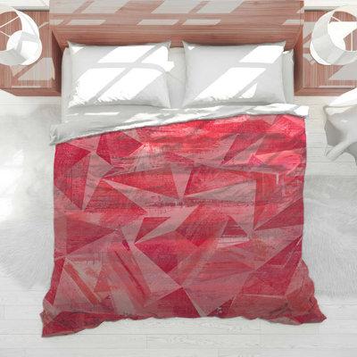 Couette aux motifs géométriques rouges