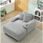 Canapé simple en velours côtelé gris avec un coussin, deux coussins, un repose-pieds et deux espaces de rangement.