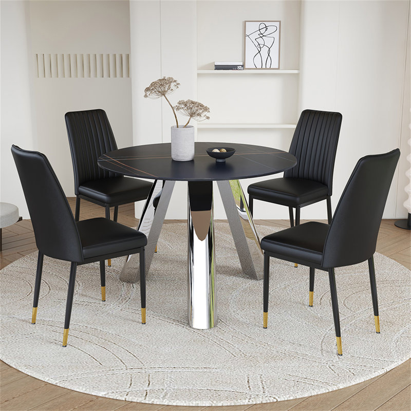 Une table de salle à manger ronde de 42 pouces avec un plateau en granit et des pieds en acier inoxydable