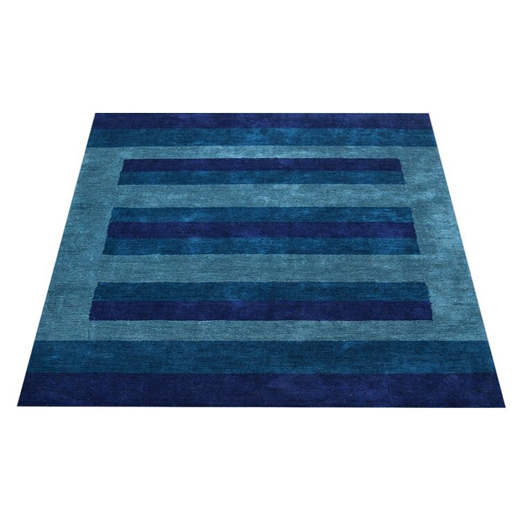 https://assets.wfcdn.com/im/72154414/resize-h755-w755%5Ecompr-r85/1411/141192676/Jarelyn+Hand-Knotted+Wool+Area+Rug+in+Blue%2FTeal.jpg