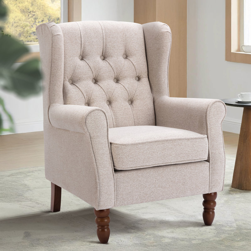Petit fauteuil d'appoint à oreilles capitonné avec accoudoirs roulés et coussin rembourré épais