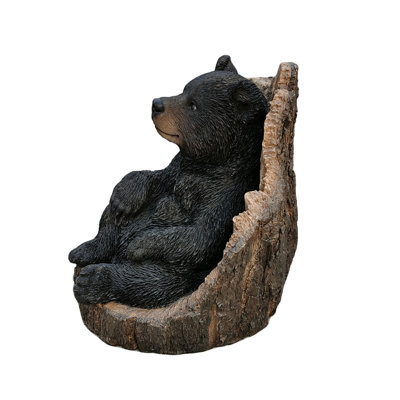 Lone Cub Haven: Intriguing Black Polyresin Bear in Stump Figurine