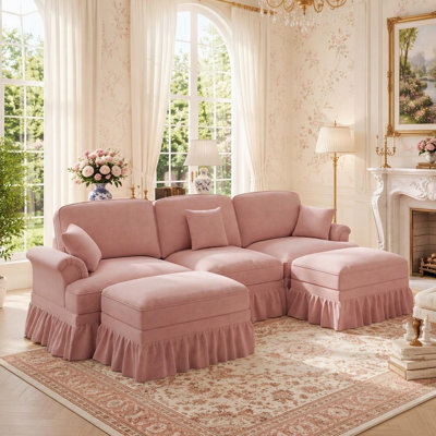 Canapé élégant de style Mid-Century, grand modèle, avec accoudoirs évasés, jupes à volants et plis amovibles et pieds fuselés, accompagné de 2 poufs amovibles.