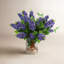 Italian Lilac Floral Arrangement In A Cylindrical Glass Vase