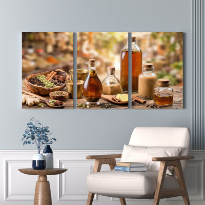 Ensemble de 3 tableaux sur toile représentant une scène de cuisine avec épices et fines herbes