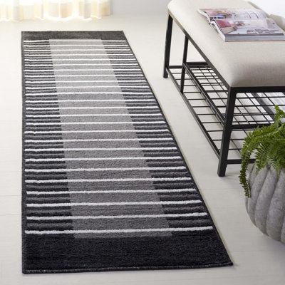 Tapis en polypropylène tissé à la machine Lilja en noir / blanc / gris