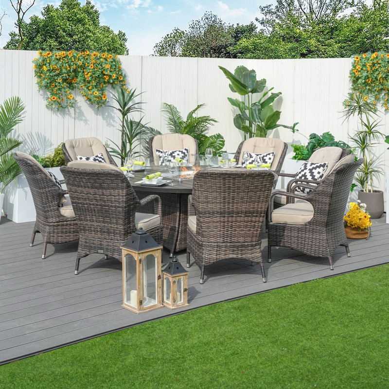 Aquiel 8 - Person Wicker Patio Dining Set with Round Table , Cushions Included