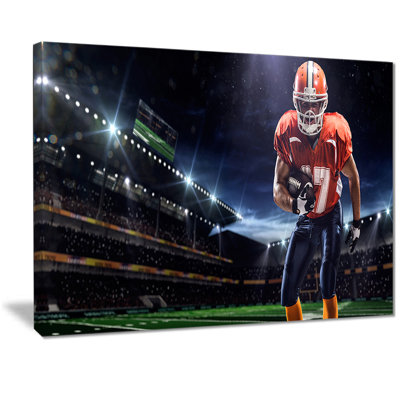 " American Footballer In Action On Stadium "