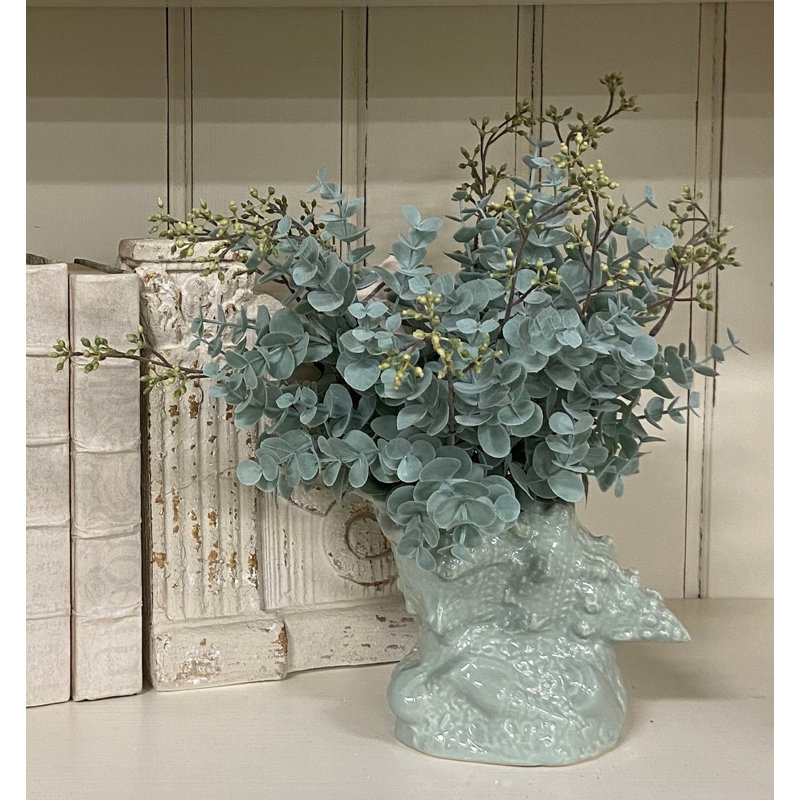 Eucalyptus Arrangement In A Shell Vase.
