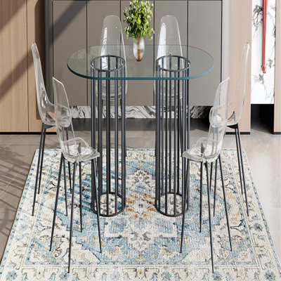 Ensemble de table et de chaises Table de salle à manger ovale en verre trempé de 71 pouces de style luxueux à double colonne noire. Jumelé avec 6 chaises en plastique transparent avec pieds en métal noir.