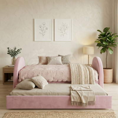 Lits de jour rembourrés en velours rose avec lit gigogne escamotable, cadre de lit incurvé moderne avec tête et pied de lit rembourrés, conception 2 en 1 amovible pour les soirées pyjama