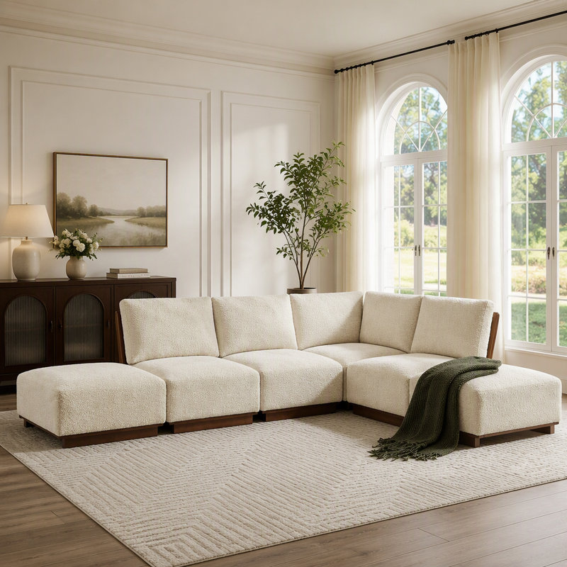 Canapé d'angle modulaire en boucle avec pouf offrant des configurations d'assise flexibles et un confort ergonomique pour les espaces de vie modernes.