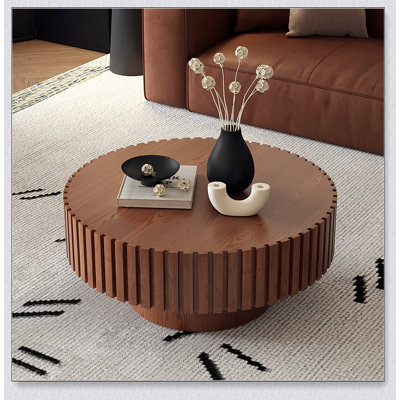 Table basse ronde avec relief fabriqué à la main, piédestal robuste et conception en forme d'olive pour les salons modernes