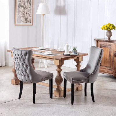 Upholstered Wing-Back Dining Chair With Backstitching Nailhead Trim And Solid Wood Legs