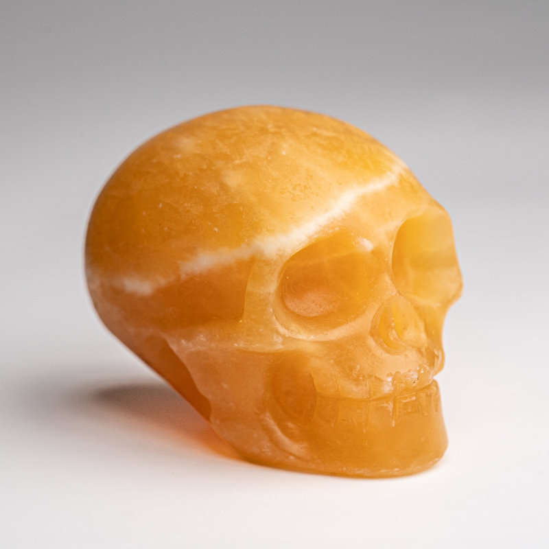 Polished Orange Calcite Skull Carving (127.4 Grams)