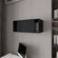 Armoire murale noire avec porte coulissante facilitant l’optimisation de l’espace de vie