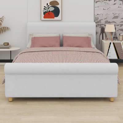 Platform bed frame with classic sleigh silhouette and high headboard anchors traditional bedrooms