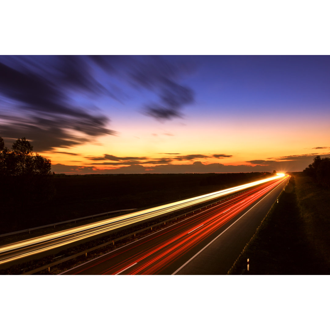 Cars Speeding On Highway von Remedios - Foto ohne Rahmen auf Leinwand