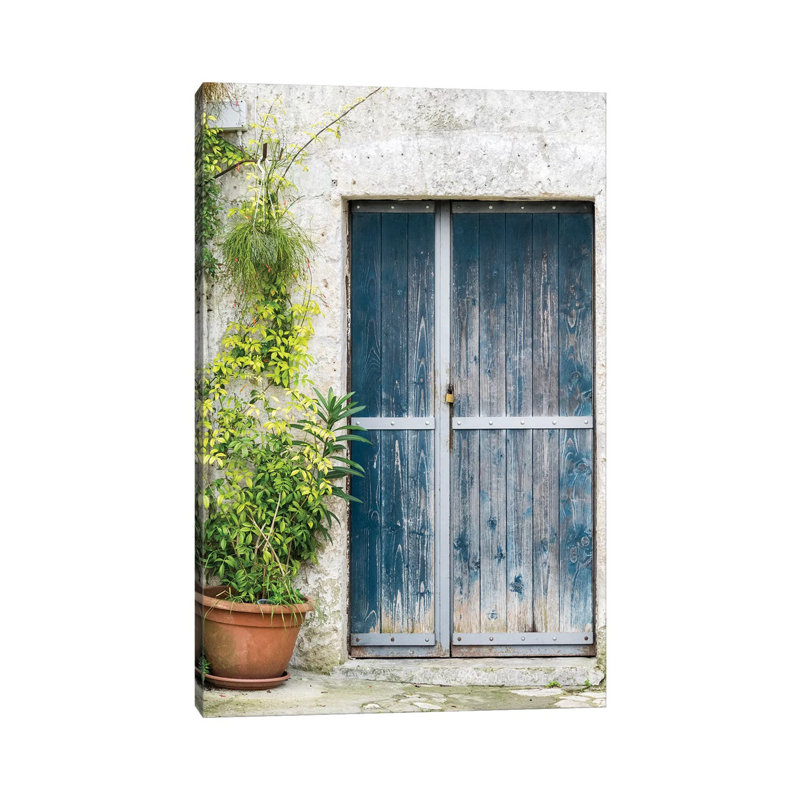 Blue Door On A Sassi House In Matera by Julie Eggers - Wrapped Canvas Print, 30.48cm H x 20.32cm W x 1.91cm D