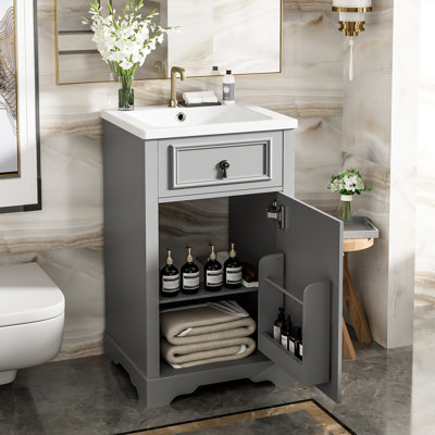 Meuble-lavabo de 50 cm avec lavabo en céramique, tablette réglable et support mural pour un rangement optimal. Porte à fermeture douce et poignées élégantes en alliage d'aluminium.