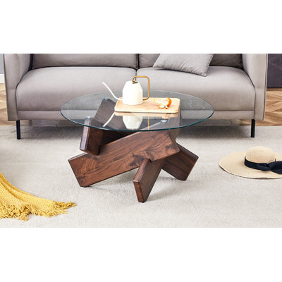Table basse ronde en verre, table basse unique au design moderne de 33,4 po. Plateau en verre trempé avec pieds en panneau de fibres à densité moyenne de couleur noyer. Convient pour le salon et la salle à manger