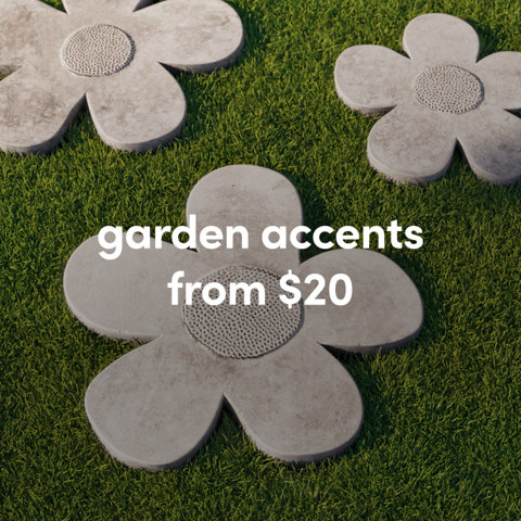Three grey concrete stepping stones shaped like flowers placed on lush green grass from $20.