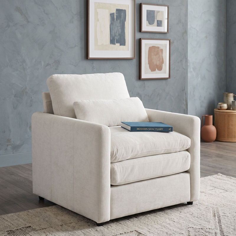 Fauteuil rembourré avec coussin double couche, accoudoirs roulés, coussin lombaire, assise profonde et dossier amovible