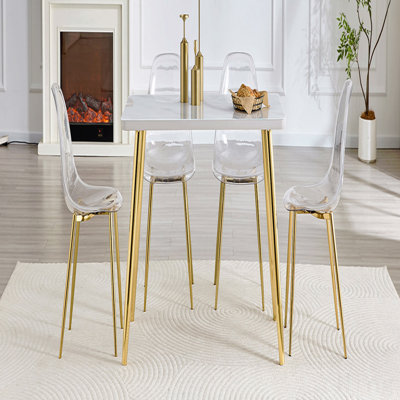 Table And Chair Set.White Imitation Marble Texture Glass Countertop + Lower Mdf Board, Gold Metal Tapered Legs.Paired With 4 Transparent Plastic Chairs With Golden Metal Legs.