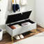 Banc de rangement rembourré en velours gris avec entrée et pieds dorés pour le salon