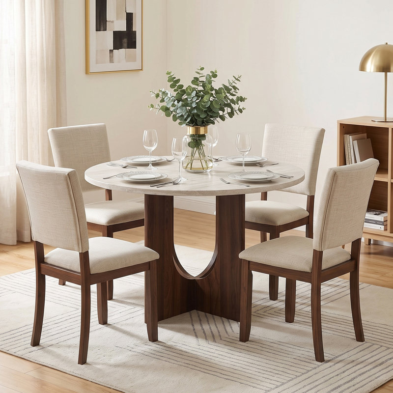 Ensemble de table et de chaises de salle à manger transitionnelles pour 4 personnes, comprenant une table ronde et 4 chaises de salle à manger rembourrées.