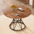 A Circular Dining Table With A Diameter Of 47.3 Inches, Featuring 4 Walnut Wood Grain MDF Tabletops, Black Hourglass Shaped Metal Brackets, And A Modern Industrial Style Dining Table For 4-6 People.-1938738446
