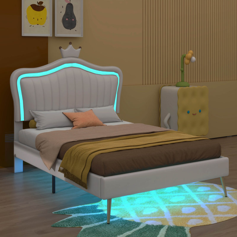 Structure de lit simple tapissier avec lumières à DEL intégrées et une élégante tête de lit en forme de couronne pour un design de princesse moderne