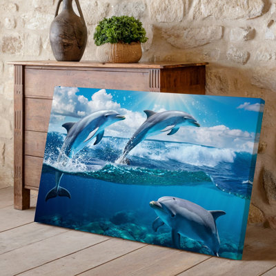 Canvas A Vibrant Underwater Scene Featuring Two Playful Dolphins Leaping Joyfully Wall Art Above The Ocean Waves With A Third Dolphin Canvas Wall Art