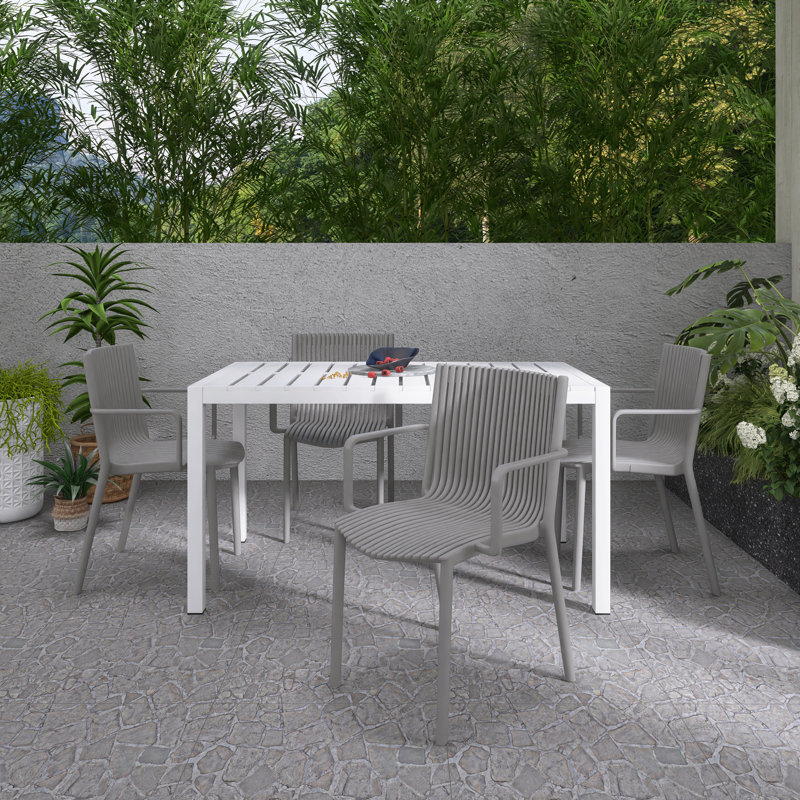 5 Piece Indoor/Outdoor Dining Set, 4 Stackable PP Armchairs and 55 Inch White Modern Long Table, White/Grey