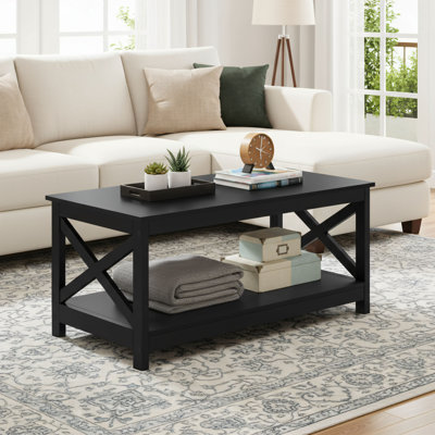 This Double-layered Black Wooden Coffee Table Features A Sturdy X-shaped Design And Comes With A Storage Shelf For Convenient Organization, Making It A Practical And Stylish Choice For The Living Room.
