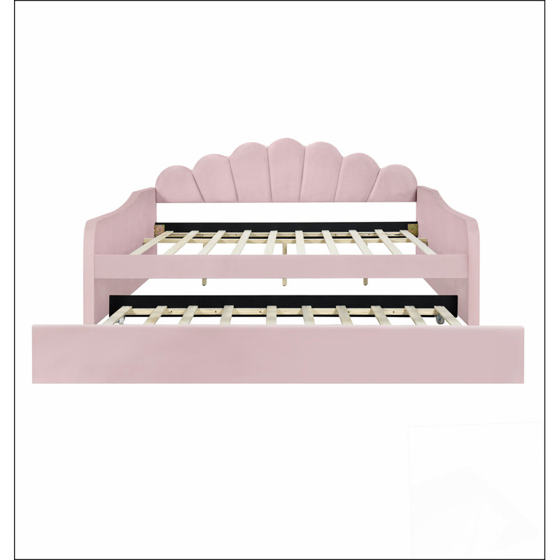 Structure de lit de jour rembourrée pleine grandeur avec dossier en forme de coquillage et lit gigogne, alliant confort et design élégant pour une utilisation polyvalente