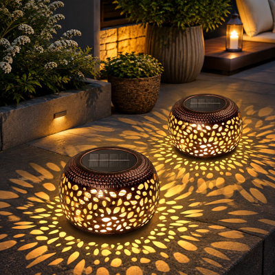 This 2 Pack of waterproof solar lanterns combines hollowed-out retro metal construction with decorative use in outside gardens, yards, and patios or on indoor tabletops, including gifting for women and Mother's Day.