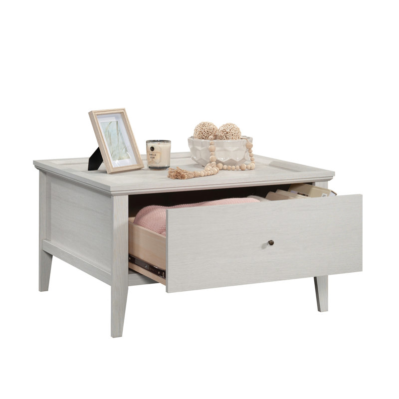 Table basse grise avec une finition latérale, un motif hexagonal et un grand espace convenant à un usage domestique