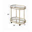 Chariot de service à finition miroir et champagne Lacole, parfait pour les réceptions élégantes et le rangement peu encombrant.