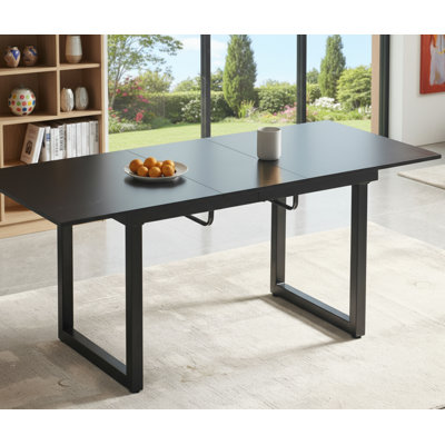 A Modern Black Square Extendable Dining Table With Metal Legs; Its Space-saving Design Makes It Suitable For Both Living Rooms And Kitchens.