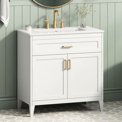 Meuble-lavabo moderne autoportant de 76 cm (30 po) avec lavabo en céramique, portes à fermeture amortie, tiroir basculant, pieds en bois massif, étagère réglable et rangements de porte.