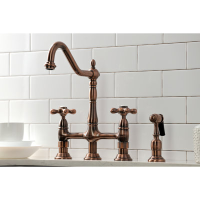 Kingston Brass Heritage Two-Handle 4-Hole Deck Mount Bridge Kitchen Faucet with Brass Side Sprayer