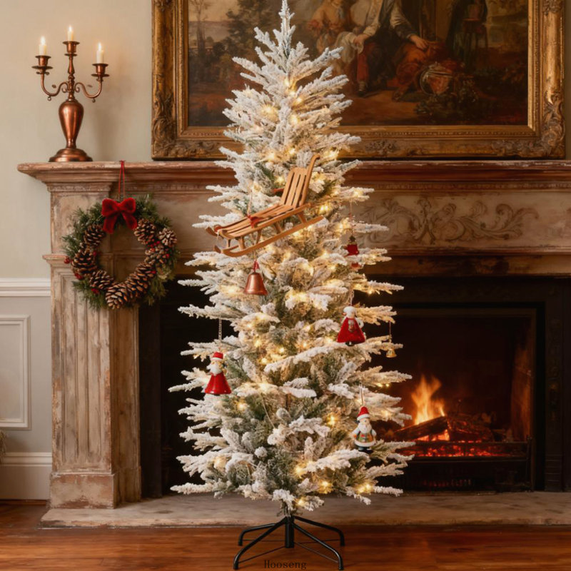 Arbre de Noël floqué avec branches enneigées et lumières jaunes chaudes