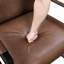 Chaise avec accoudoirs en similicuir brun avec structure en métal pour salon