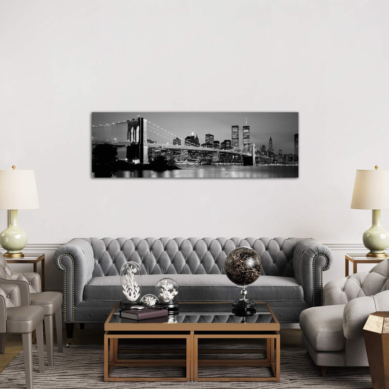 Illuminated Brooklyn Bridge With Lower Manhattan's Financial District Skyline In The Background In B&W, New York City, New York by Panoramic Images - Wrapped Canvas Panoramic Print