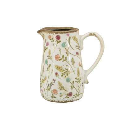 Round Ceramic Pitcher Vase With Multi-Colored Floral Motifs, Handcrafted Texture, Weathered White Finish, And Versatile Decorative Function.
